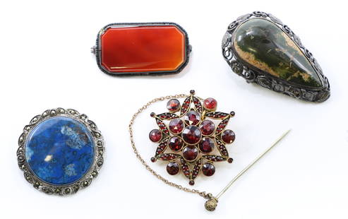 Victorian Brooches: Group of five brooches including a round lapis brooch in a marcasite-set silver-tone mount; an elongated Scottish agate brooch with carved teardrop form in pierced sterling silver mount; an oval red c