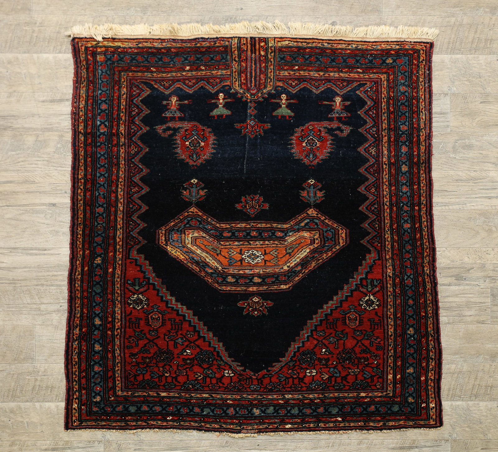 Persian Bibikabad Saddle Cover: Hand woven wool, arabesque centerpiece medallion with dancing female figural motifs in a jagged edge field, floral and vine scroll spandrels and borders, in multi-colors of red, blue, green and yellow