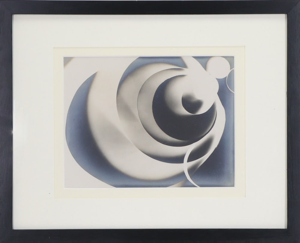 Man Ray (1890 - 1976) Photographic Print: Gelatin silver print after the 1922 rayograph, tipped to card mount, Untitled (Plate 4) from the album "Champs Delicieux". Unknown edition; unmarked. Pencil inscription on cardboard in the frame, "Man