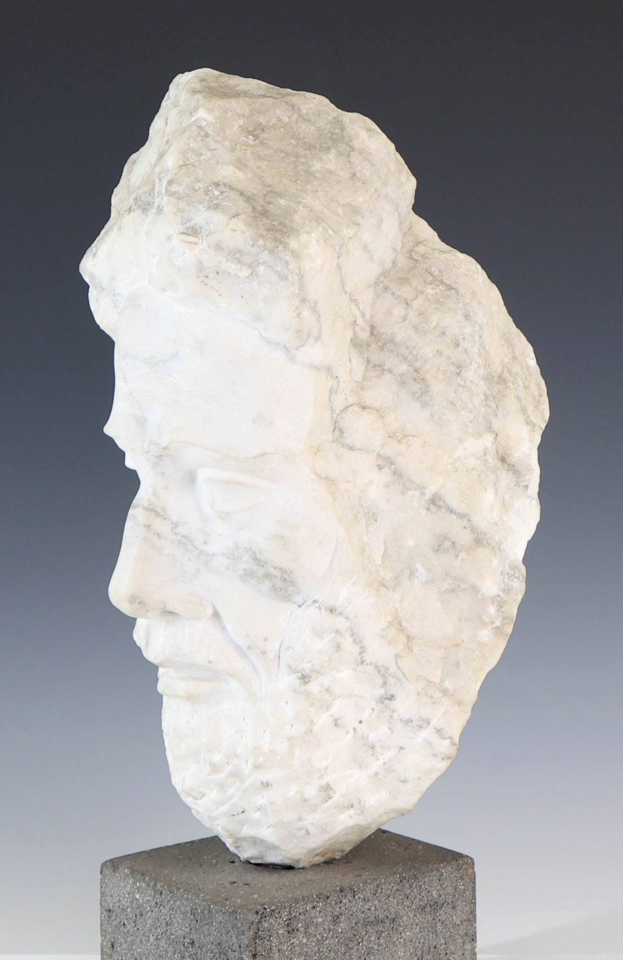 Renzo Palmerini (B. 1940): Expressionist marble sculpture, head of an elderly man, mounted to a granite plinth, signed en verso. 20"h x 9"w x 9"d