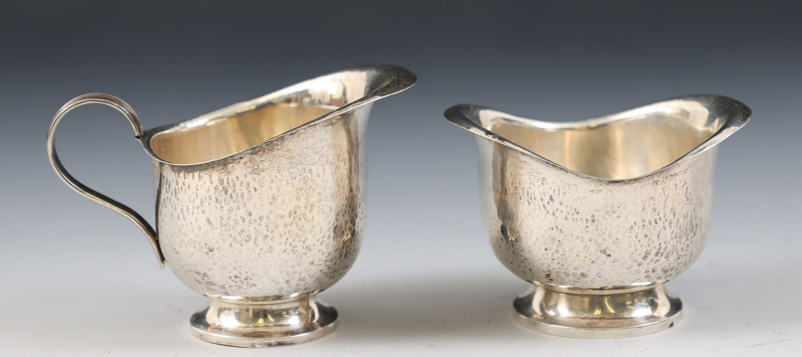 Theodor Muller 800 Silver Creamer and Sugar: German 800 silver creamer and sugar, hand hammered, made by Theodore Muller, court jeweler to the duke of Saxe-Weimar, late 19th - early 20th C. creamer 2.75"h x 3.75"w, sugar 2.25"h x 3.25"w. 2.65 oz