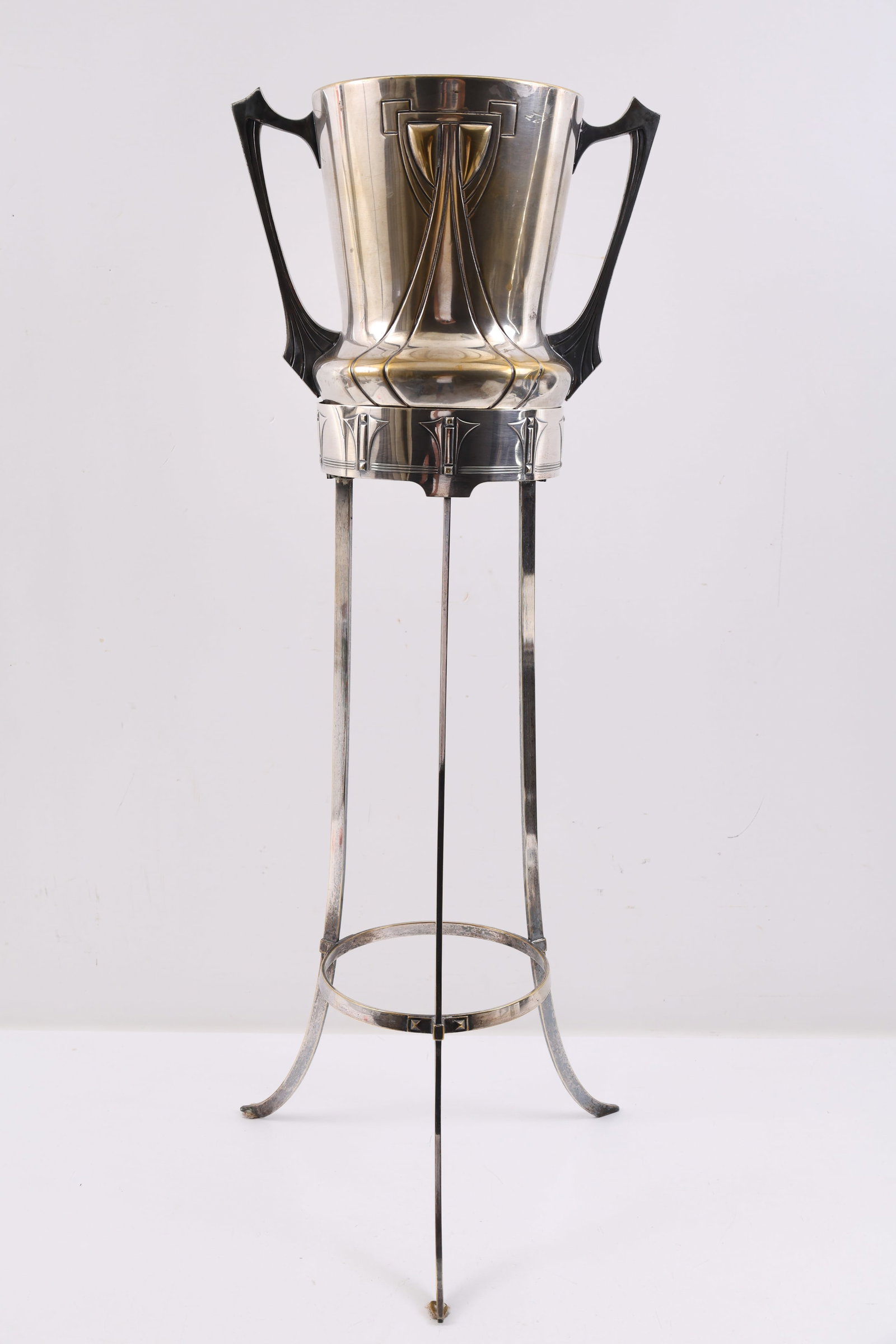 WMF Silver Plate Wine Cooler and Stand: German Jugendstil / Art Nouveau silver plate wine cooler bucket with handles, decorated with sweeping geometric motifs, on a matching tripod stand with outswept feet. The bucket marked. Overall 34"h x