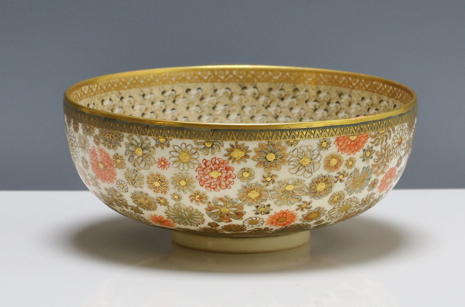 Japanese Satsuma Pottery Bowl: Meiji - Taisho era bowl with mille fleur motif to the exterior and thousand cranes motif to the interior, accented by geometric borders. Unidentified makers mark to the foot. 2.25"h x 5.25"w