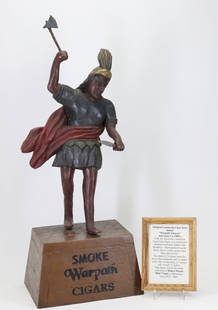 Countertop Cigar Store Indian: Folk art carved and painted wood countertop cigar store figure depicting a male Native American in headdress, holding a tomahawk and knife on a base labeled "Smoke Warpath Cigars". Polychrome painted