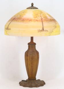 Attr. Pittsburgh Reverse Painted Lamp: Arts and Crafts two-light table lamp with a reverse painted shade depicting an autumn landscape, with a bronze finished vasiform base. No marks noted. One light is in working order, the other does not