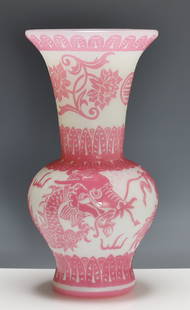 Attr. Steuben Acid Etched Glass Vase: Acid etched rosaline and alabaster glass baluster vase in a variation of the "Chinese" pattern, depicting a dragon and flaming pearl in flight among clouds on a textured roundel ground, below flowers