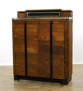 Dental Cabinet by The American Cabinet Co.: Walnut veneered case and chrome, backsplash with lidded compartments, nine side by side graduated drawers (eighteen total), turret pillared feet. glass centerpiece to the bacl splash is loose. 50"h x