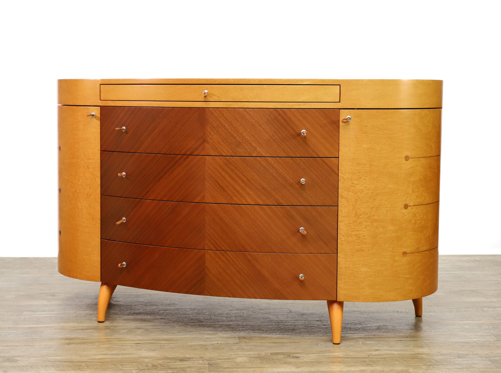 Maurice Villency Bird's Eye Maple and Satinwood Dresser: Bird's eye maple serpentine dresser, featuring one small drawer over four drawers with matched satinwood veneers and leather pulls, flanked by rounded side cabinets with inlaid satinwood bands and lea