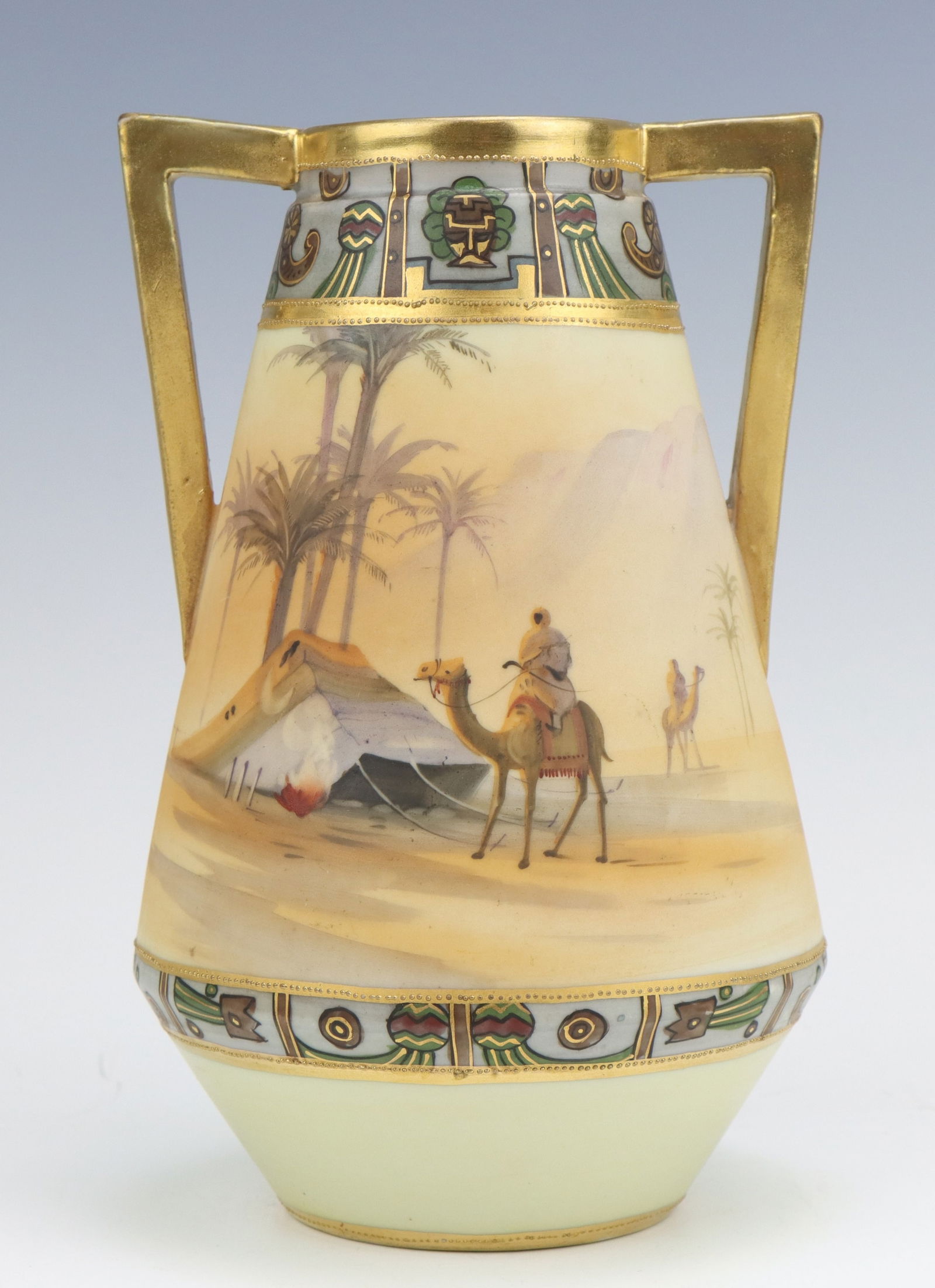 Nippon Porcelain Vase: Nippon porcelain vase, c. 1891-1921, hand painted Egyptian desert, 2 handles, marked, jeweled detailing, 7.75"h x 5"w x 4.75"d.