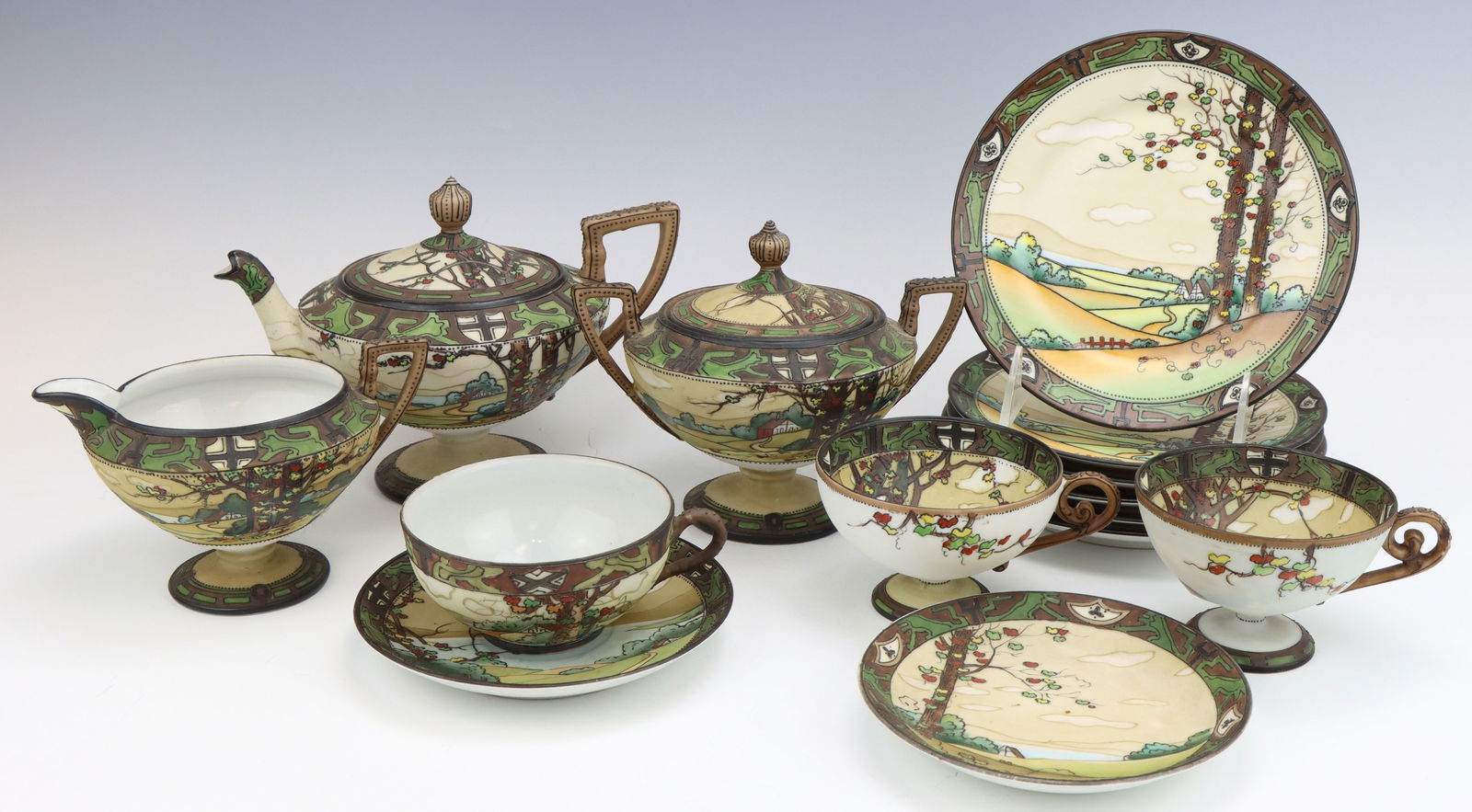 Nippon Dark Woodland: Nippon Dark Woodland porcelain partial tea set, includes teapot, sugar bowl, creamer pitcher, teacups (2), saucer (1), dessert plates (6), c. 1891-1921, hand painted moriage decoration, marked, teapot