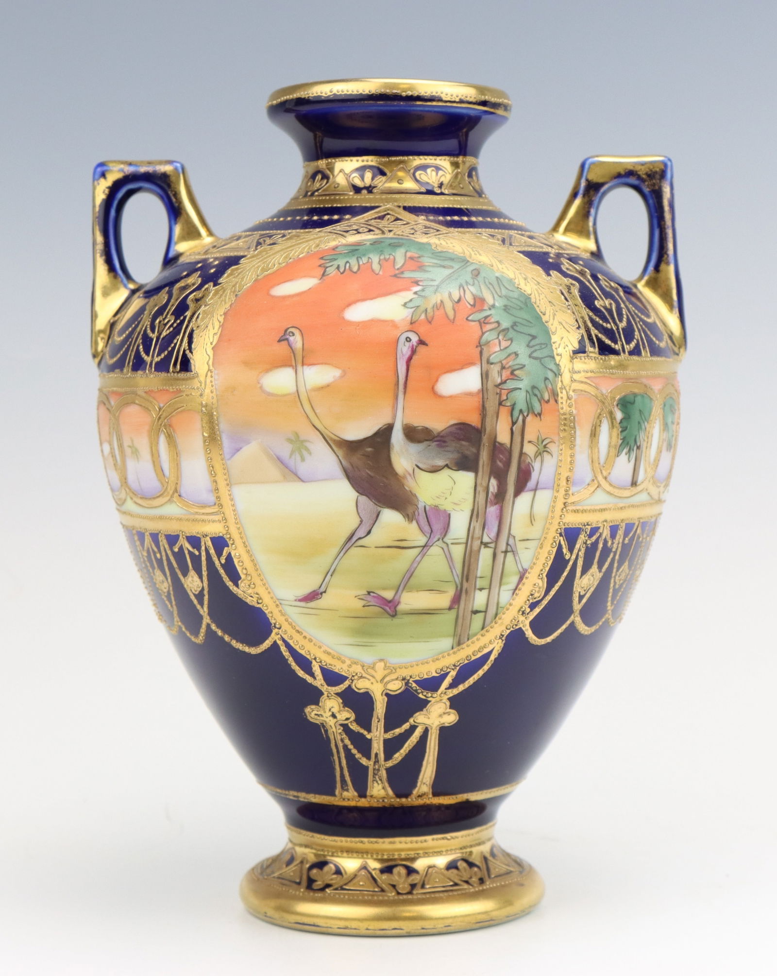Nippon Porcelain Vase: Nippon porcelain vase, c. 1891-1921, cobalt hand painted Egyptian desert with ostriches, moriage decoration, marked, 8"h x 6"dia.