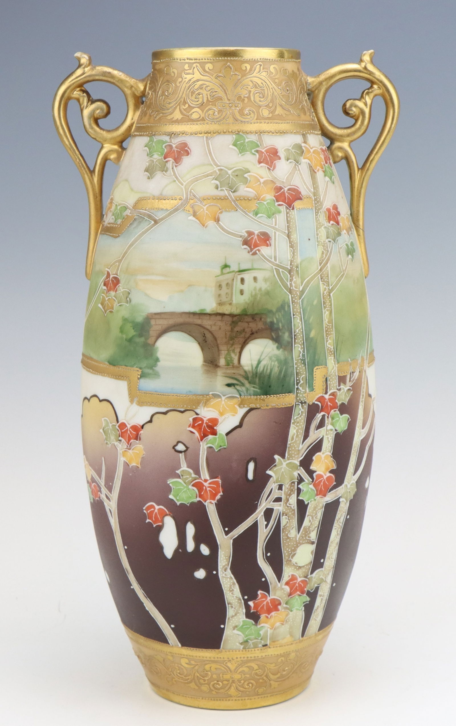 Nippon Porcelain Vase: Nippon porcelain vase, c. 1891-1921, hand painted autumn scene, moriage decoration, damage to one handle noted in images, marked,11.5"h x 6"w x 5"d.