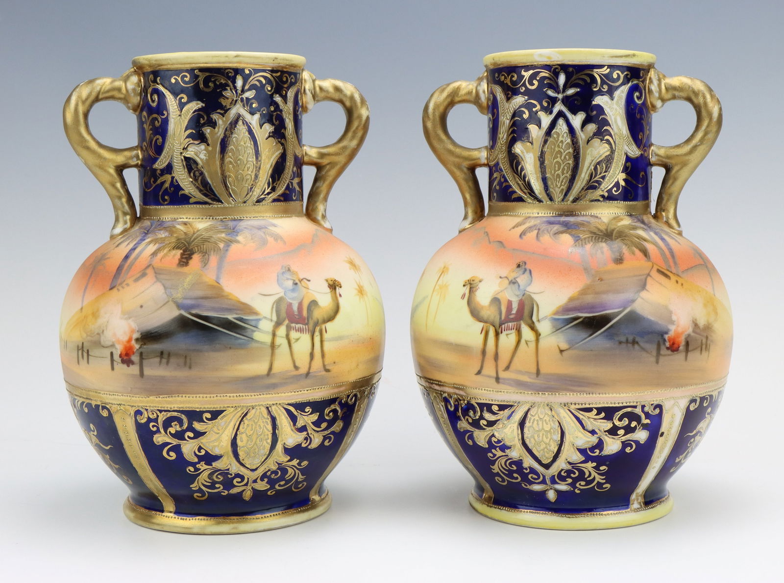 Noritake Porcelain Vases: Noritake porcelain vases (2), marked, Egyptian desert, hand painted, handles, cobalt, each 8"h x 5.5"dia.
