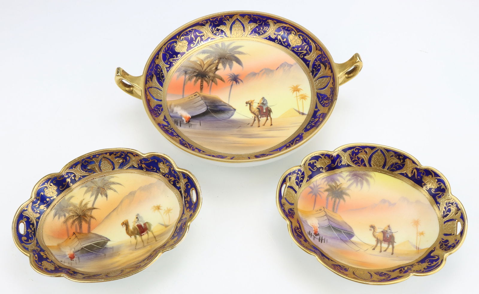 Noritake Porcelain Bowls: Noritake porcelain footed vegetable serving bowl and scalloped edge bowls (2), all marked, all hand painted Egyptian desert pattern, largest 2.5"h x 8.75"w x 7"d.