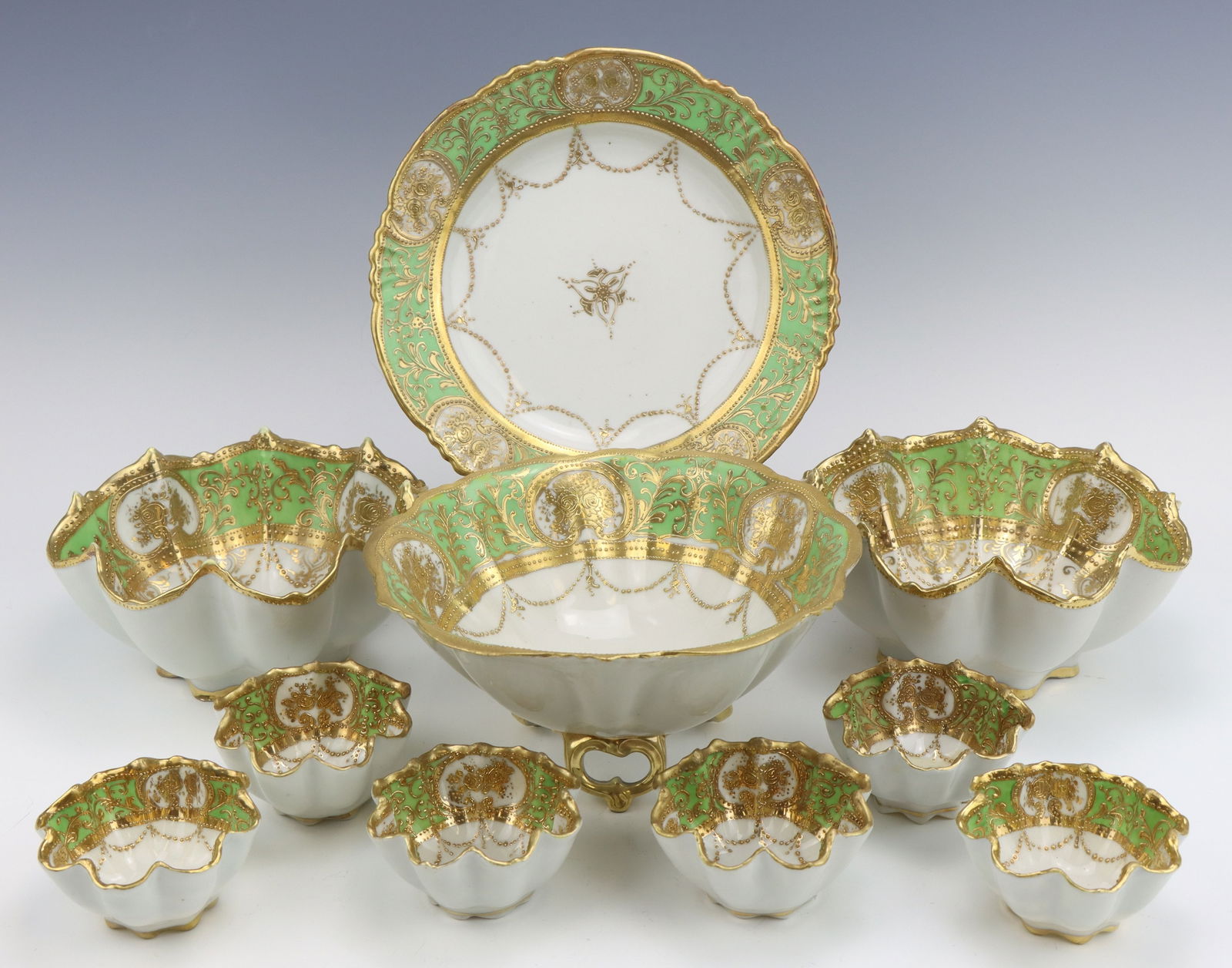 Nippon Porcelain: Nippon porcelain serving platter, bowls (3) and nut bowls (3), c. 1891-1921, hand painted moriage decoration, marked, one nut bowl has crack through the middle and is repaired, largest bowl 3.5"h x 7.