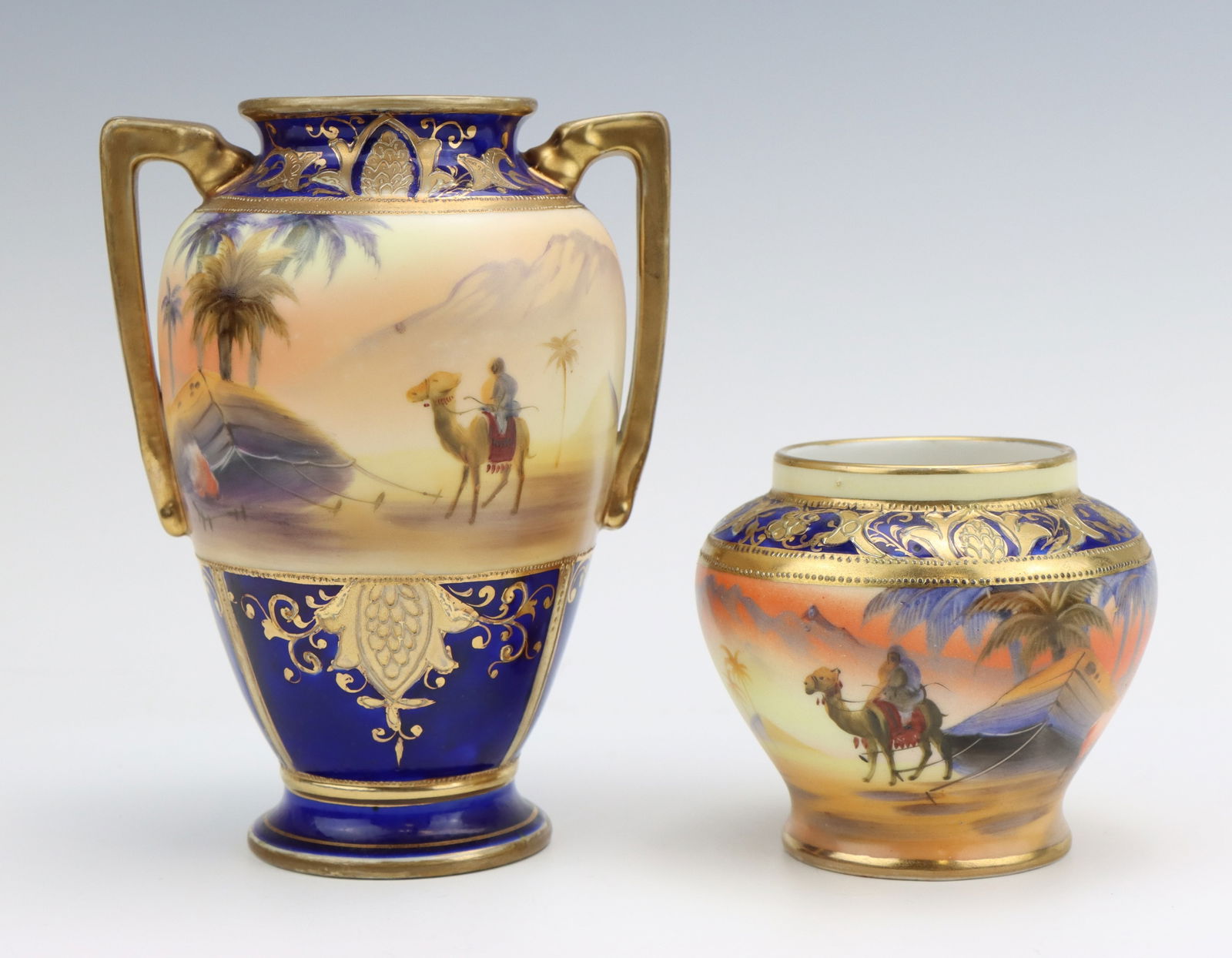 Nippon Porcelain Vases: Noritake porcelain vases (2, 2 styles), hand painted Egyptian desert pattern, marked, cobalt, moriage decorated, largest 5.5"h x 4"w x 3.25"d.