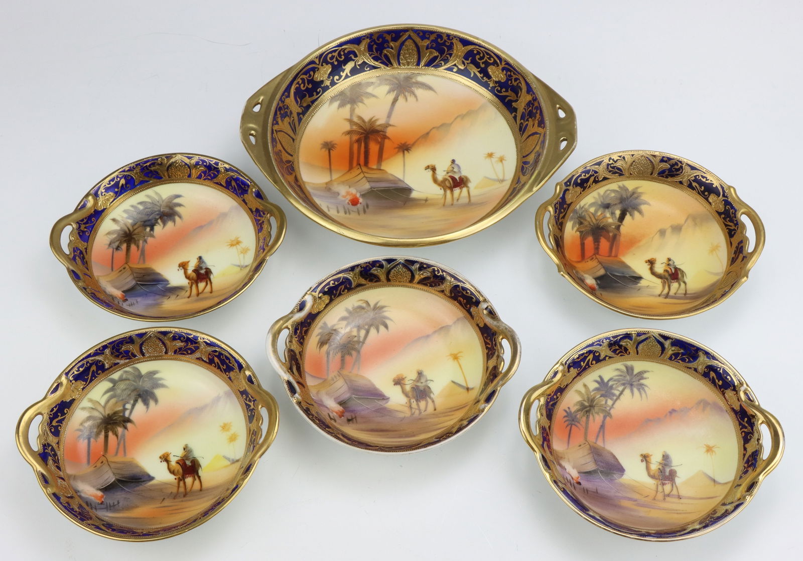 Noritake Porcelain Bowls: Noritake porcelain nut bowls (5, larger nut serving bowl and 5 individual nut bowls), hand painted Egyptian desert pattern, marked, largest 1.75"h x 8"w x 6.75"d.