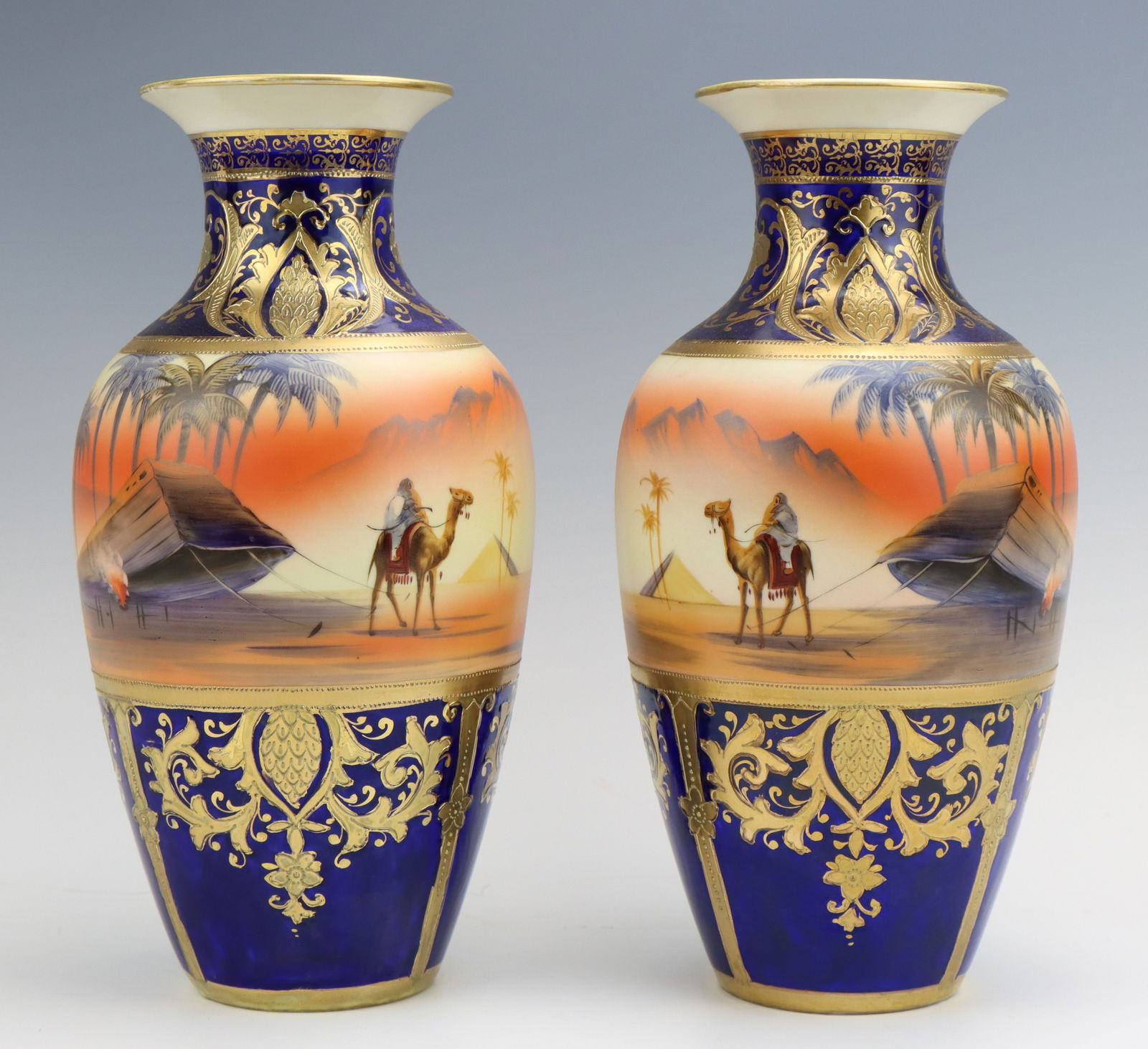 Nippon Porcelain Vases: Noritake porcelain vases (2), hand painted Egyptian desert pattern, cobalt, moriage decoration, marked, each 10"h x 4.75"dia.