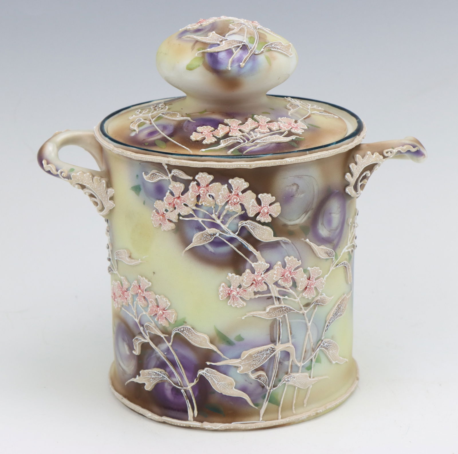 Nippon Porcelain: Nippon Royal Moriye porcelain lidded jar, hand painted floral motif with moriage decoration, marked, 6.5"h x 6.75"w x 4.5"d.
