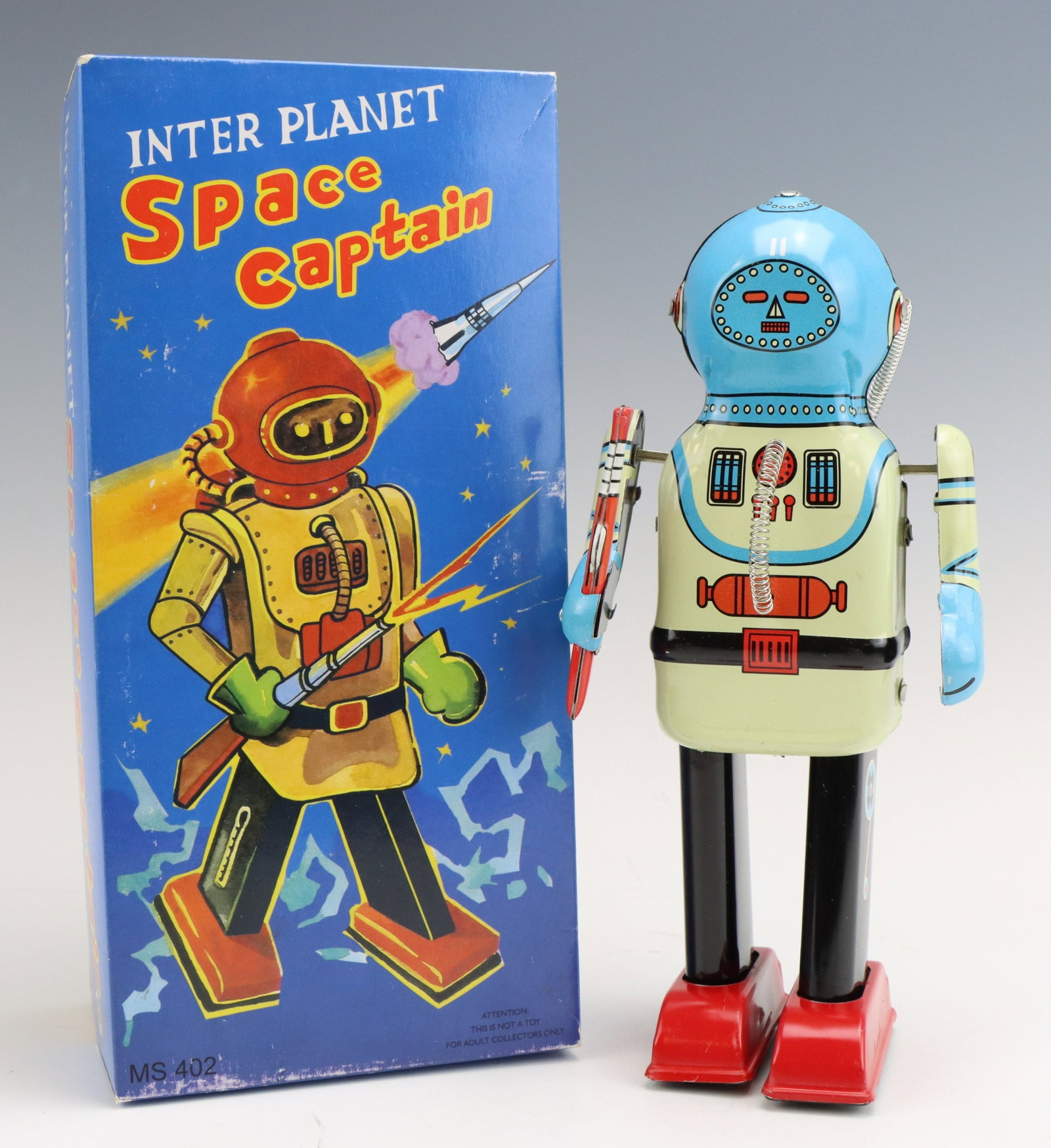 Inter Planet Space Captain: Tin litho Inter Planet Space Captain robot. Includes original box and wind-up is functional. Box measures 3.25”h x 4.5”w x 9.5”d