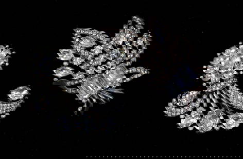 Eisenberg Rhinestone Brooches: Eisenberg brooches with clear rhinestones in layered floral and scroll motifs. One brooch is marked Eisenberg Original, the