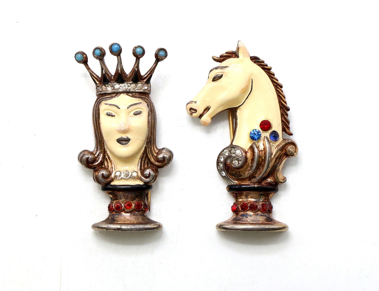 Trifari Sterling Queen And Knight Brooches: Trifari sterling brooches featuring a chess queen and knight theme. Queen brooch includes enamel details, rhinestone accents, and a crown motif. Knight brooch features enamel details, rhinestone embel