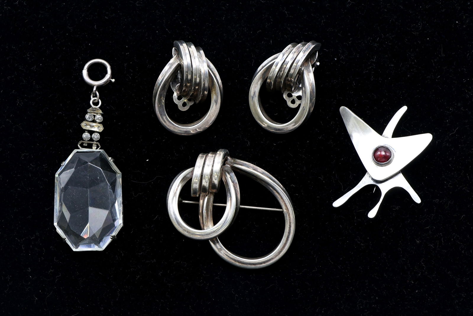 Jomaz, Ed Wiener, and Sterling Silver Jewelry: Jomaz and Ed Wiener signed pieces including sterling silver modernist brooch with red cabochon, crystal pendant marked 'Sterling,' and matching Jomaz sterling earrings and brooch. Total of 5 pieces. O