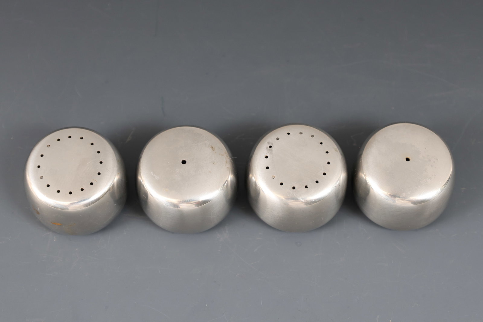 Georg Jensen Stainless Steel Salt and Pepper Shakers: Danish Modern set of salt and pepper shakers. The stoppers show wear/corrosion. (4) pieces. 1"h x 1.25"w