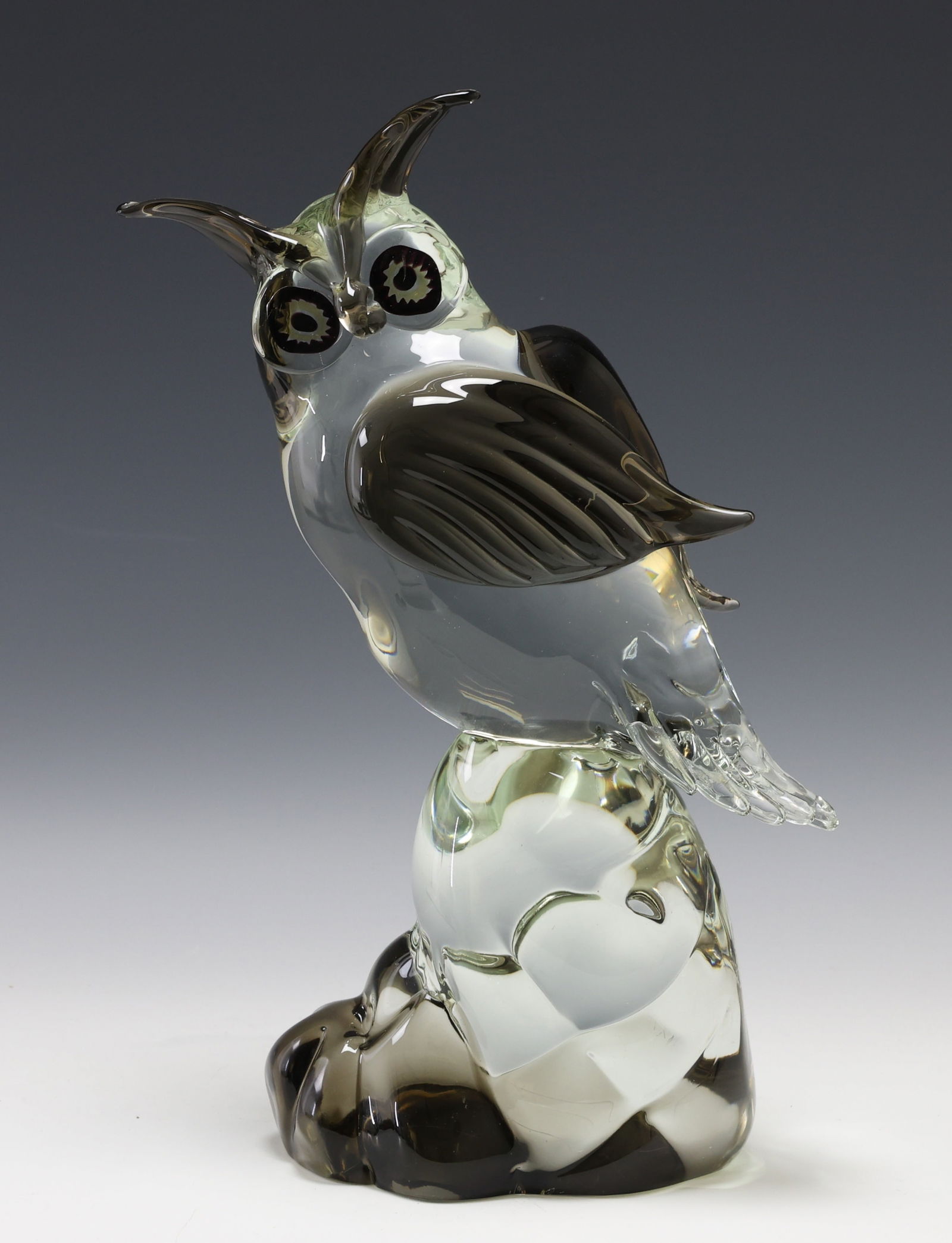 Licio Zanetti Murano Glass Owl Sculpture: Italian sculpture of an owl perched on a rock, made of clear, smoked, and tinted blown glass, signed to the foot. 16"h x 6.5"w x 4.5"d