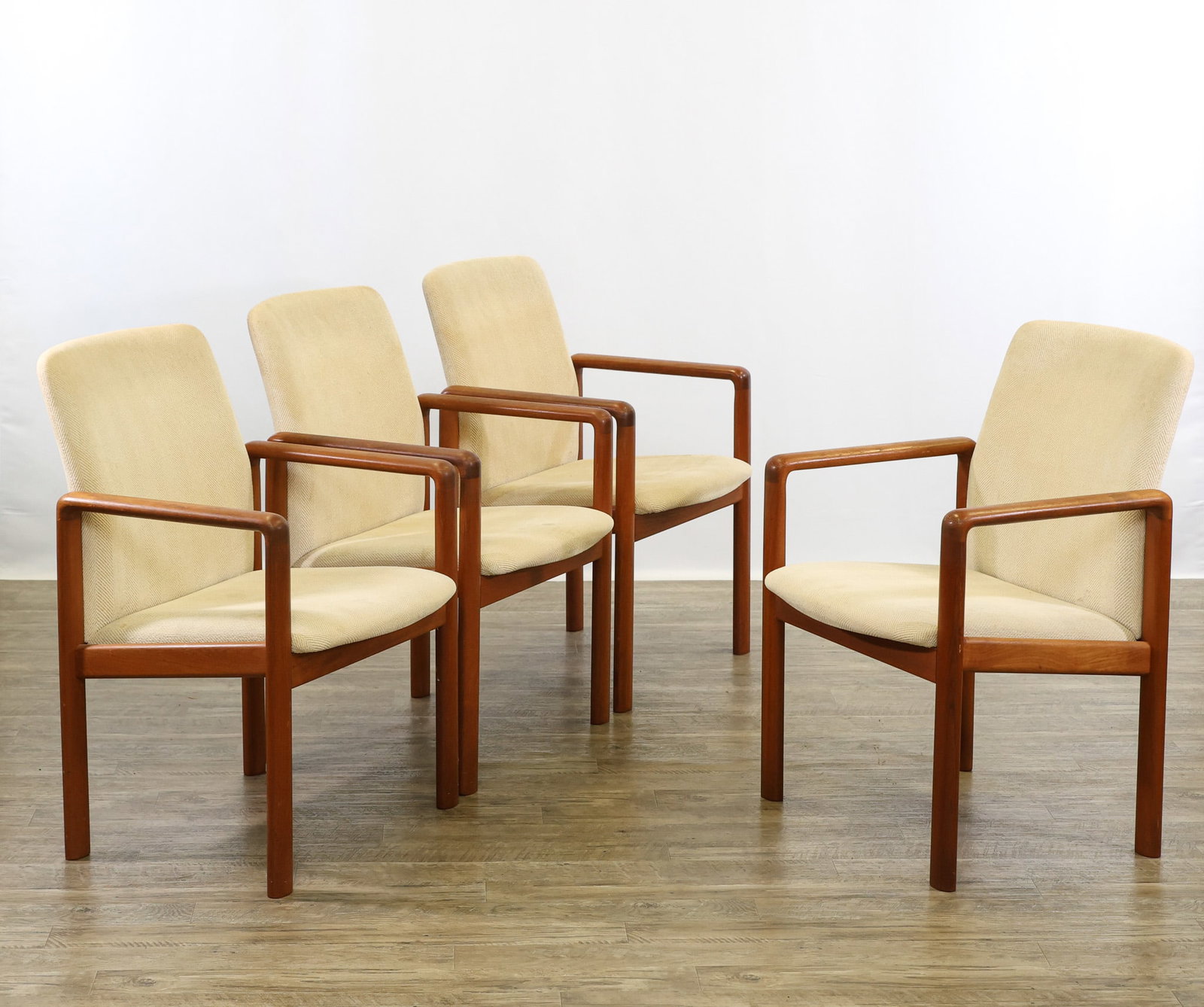 Teak Armchairs: Danish Modern style teak armchairs with shaped loop supports/arms, sloped seats, and outswept backs, with white herringbone upholstery. Wear including scuffs/abrasions to the wood, and stains to the u