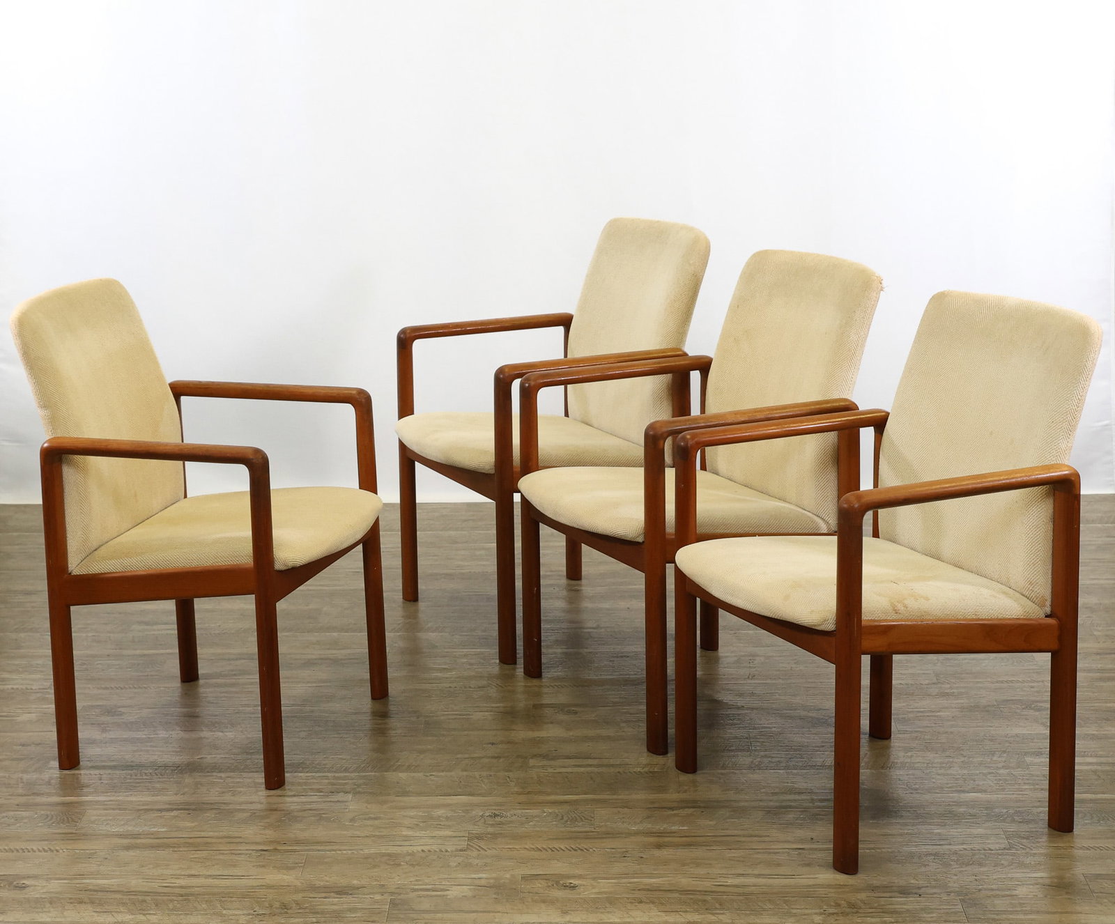 Teak Armchairs: Danish Modern style teak armchairs with shaped loop supports/arms, sloped seats, and outswept backs, with white herringbone upholstery. Wear including scuffs/abrasions to the wood, stains and tears to