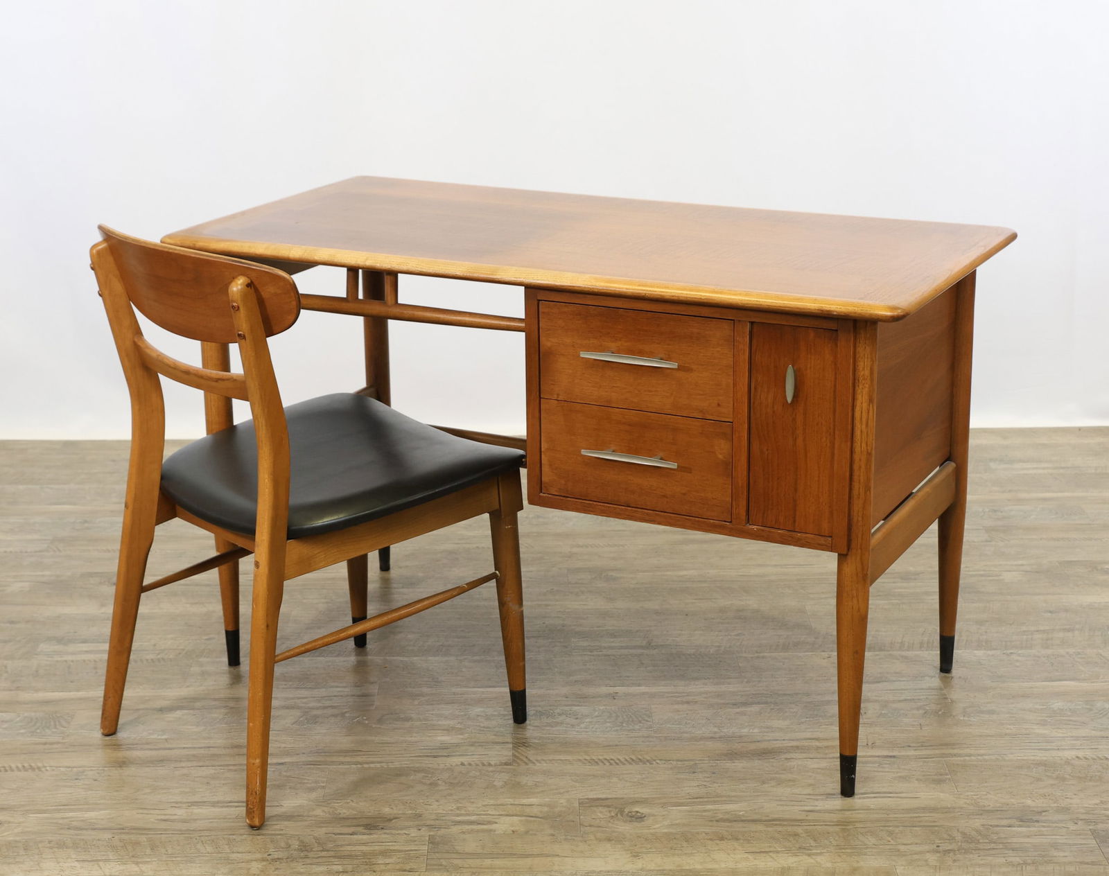 Lane "Acclaim" Desk and Chair: Walnut desk no. 900-20, the top with exposed dovetails and crossbanding, featuring a configuration of two drawers and a file drawer, on cigar legs with ebony ferrules, a cigar top stretcher and lower