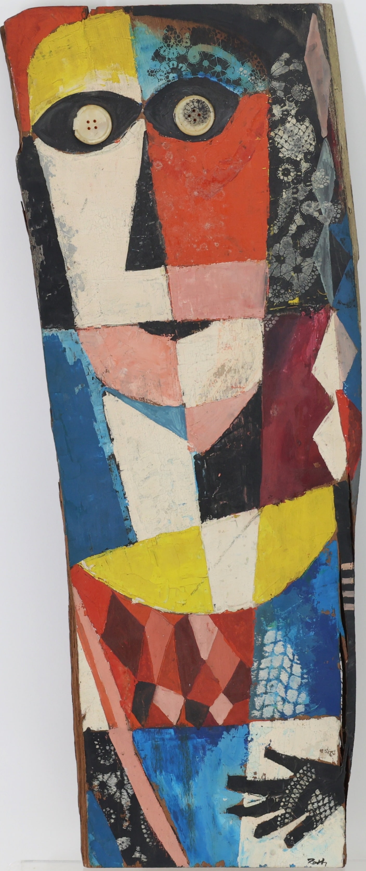 Wolfgang Roth (1910 - 1988): Oil on worked wood, SLR. Stylized totemic figure with geometric color blocks, button eyes, and patterned elements. 24"h x 9.25"w overall