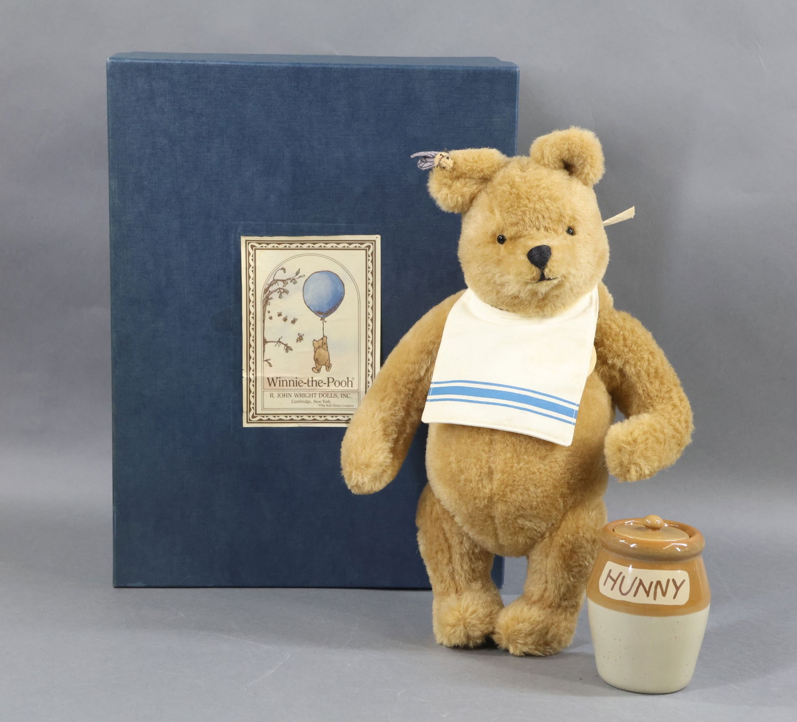 R. JOHN WRIGHT: 14" 1991 "Winnie-The-Pooh" Honey Bear in OB. Ltd. Ed. 4075/5000. COA. Condition: some age wear on box. This lot is being sold AS IS.