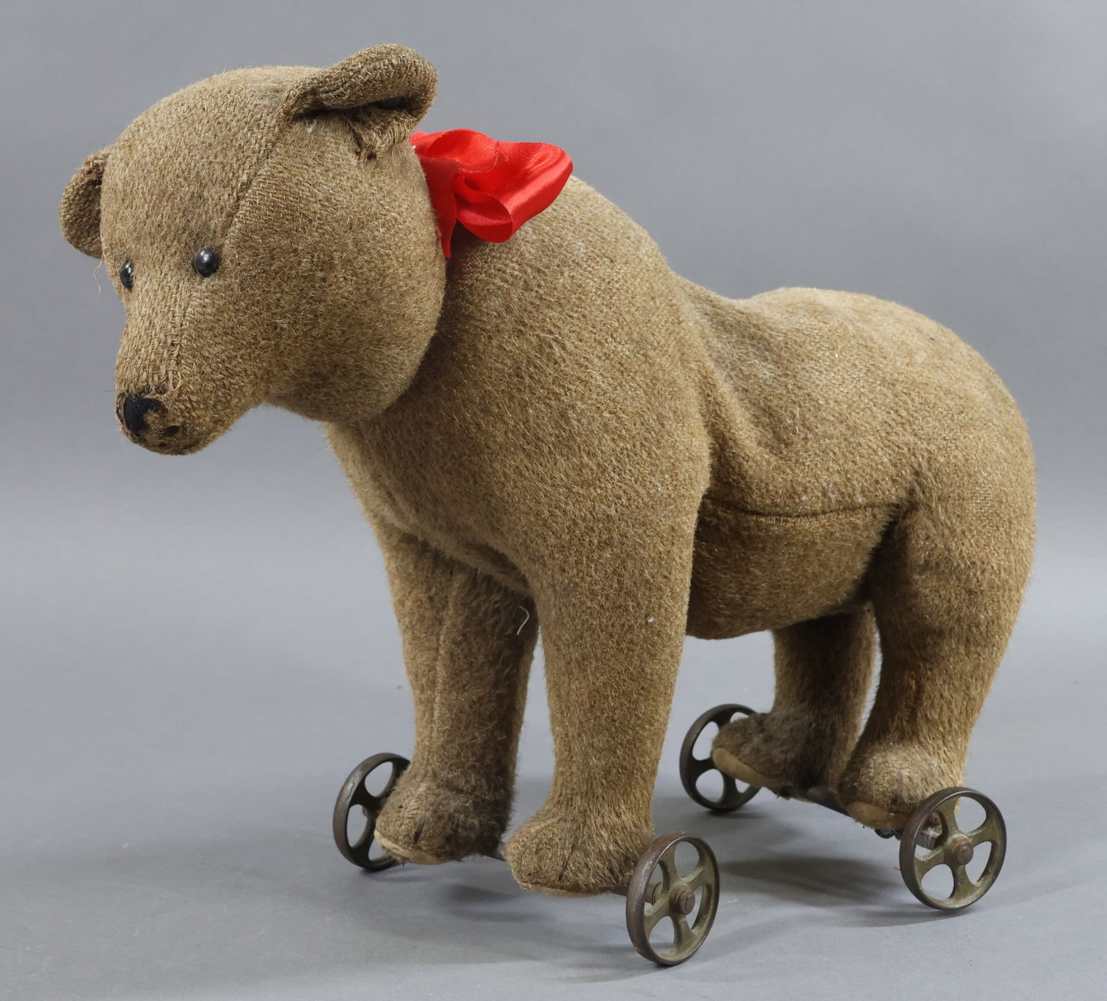 VINTAGE STEIFF.: 12" T Tagged Steiff "Bear" Pull Toy. Early 1900's. Short brown wool plush, black shoe button eyes. Swivel neck. Early silver raised button with STEIFF in upper case letters, the second "F" wrapping ba