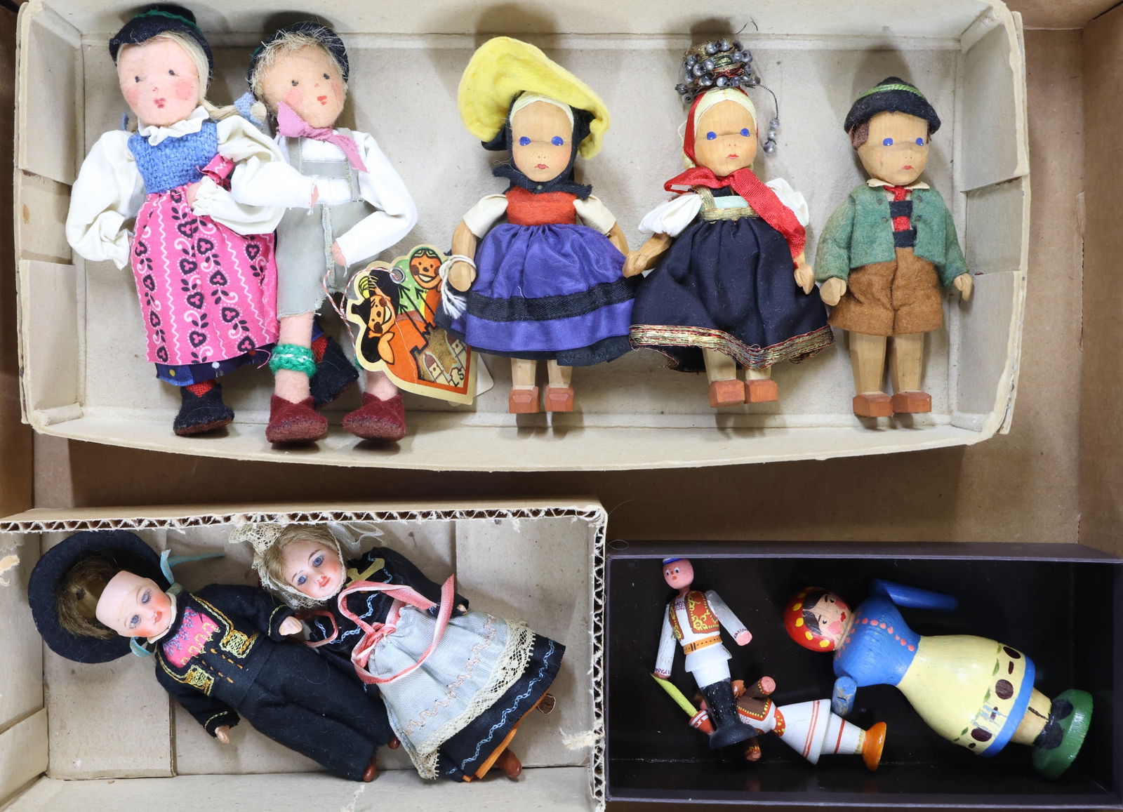 DOLLS REPRESENTING FOREIGN COUNTRIES.: LOT. Mixed dolls of different materials and countries. FRANCE - 4 3/4" antique bisque head couple - PARIS UNIS FRANCE (in oval) 301. All original provincial dolls with painted features, mohair wigs, 5