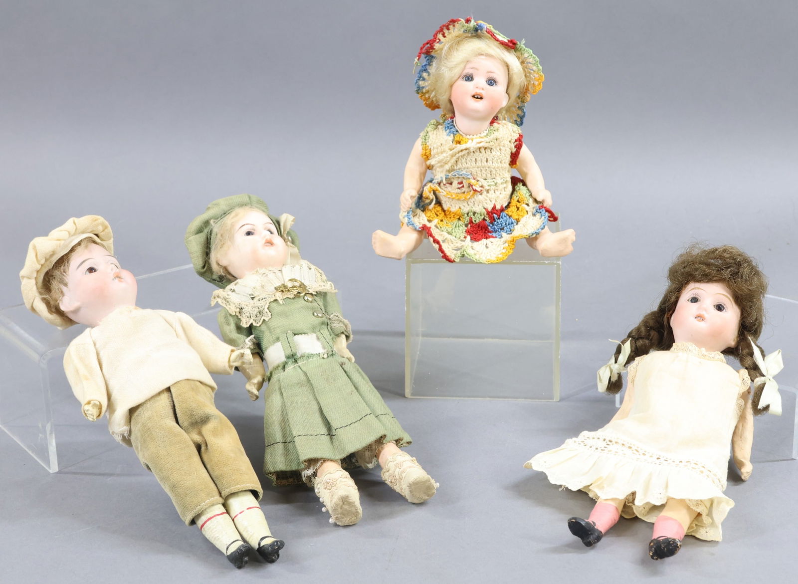 ANTIQUE GERMAN DOLLS 10"/UNDER.: LOT of (4) bisque dolls with open mouths, 5 pc. papier mache bodies, antique clothing. Doll 1) 9" Boy doll marked (crossed bones symbol) 201.17/0 DEP. Stationary brown eyes, brown mohair wig. Clothing