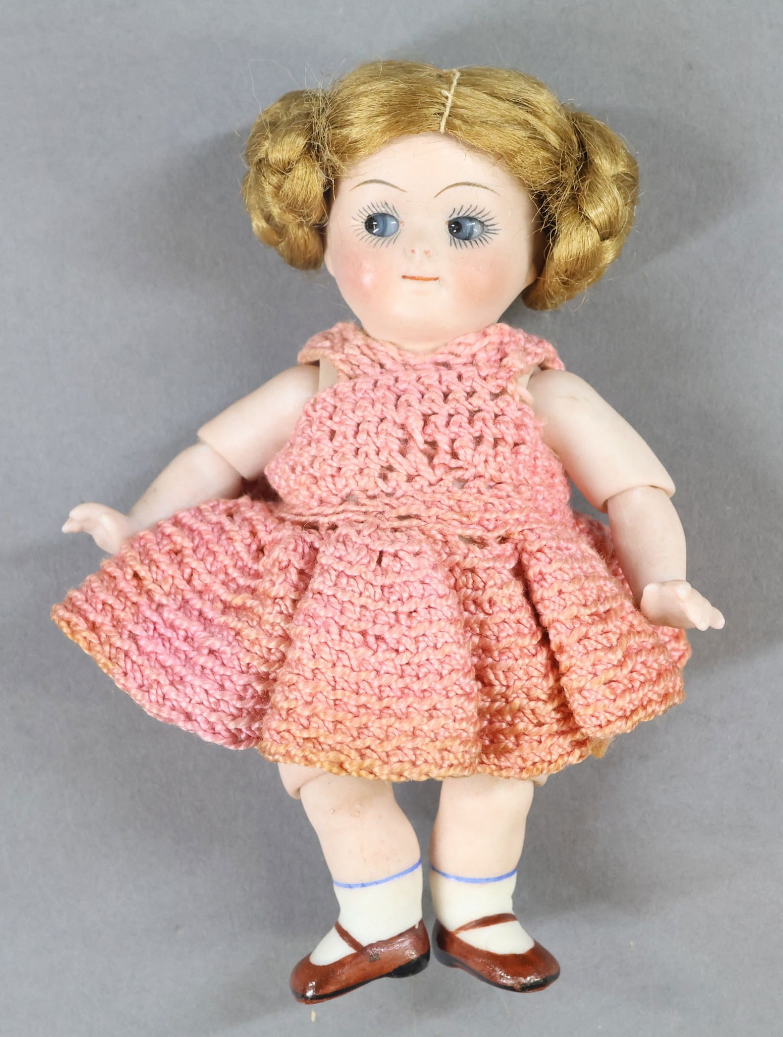 ALL BISQUE - GOOGLY EYE.: 5" 111 1 (Kestner) Doll with blue glass eyes, watermelon smile, brown coiled braid wig. Jointed elbows and knees, stiff neck. Painted shoes/socks. Dressed in vintage crocheted outfit. Condition: head
