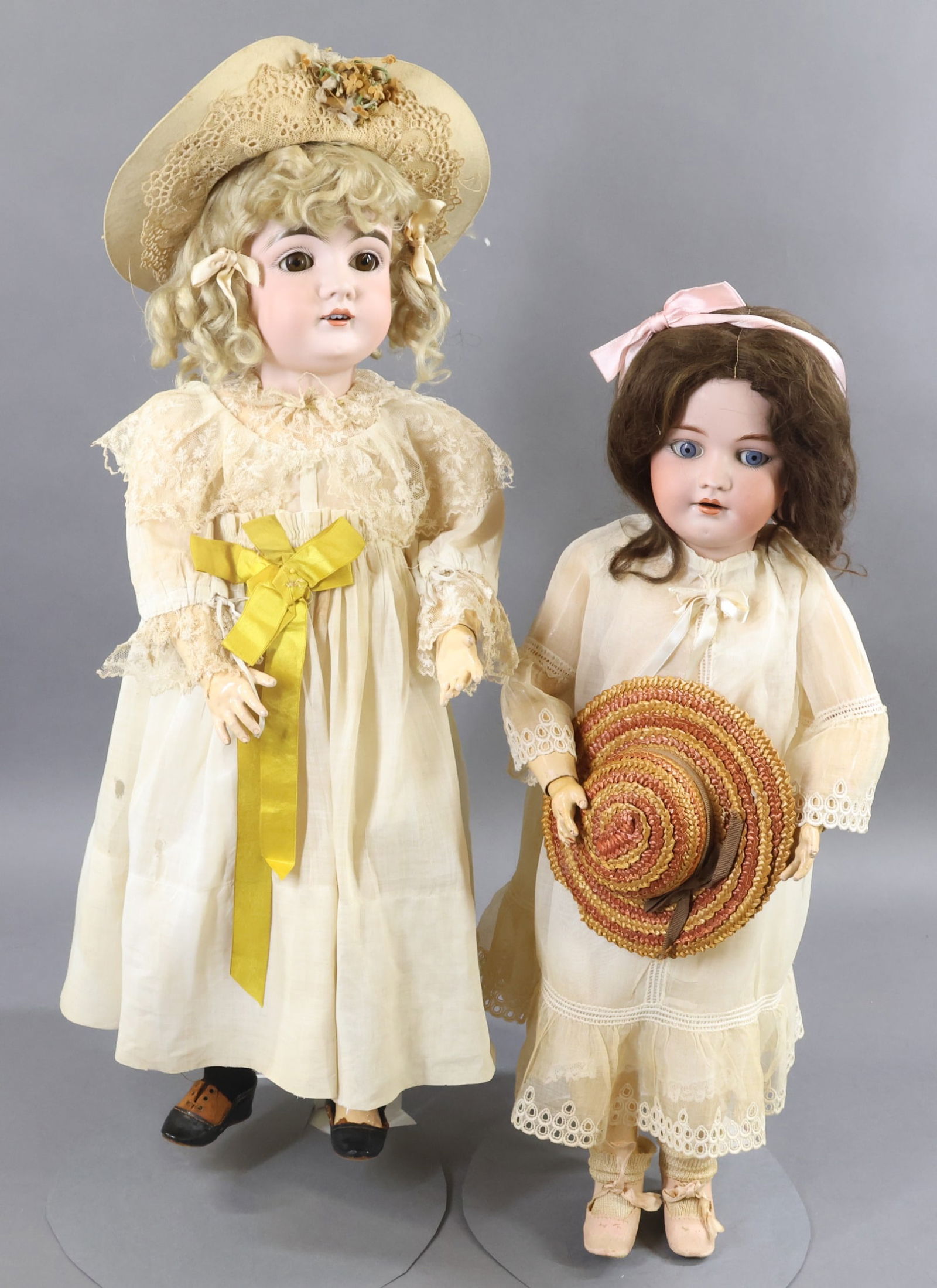 ANTIQUE GERMAN BISQUE DOLLS.: Pair of dolls. Both dolls have open mouths, original wigs, papier mache jointed bodies and are wearing antique white cotton clothing and antique shoes. Doll 1) 23" K. MADE IN GERMANY 14. 146 (kESTNER)