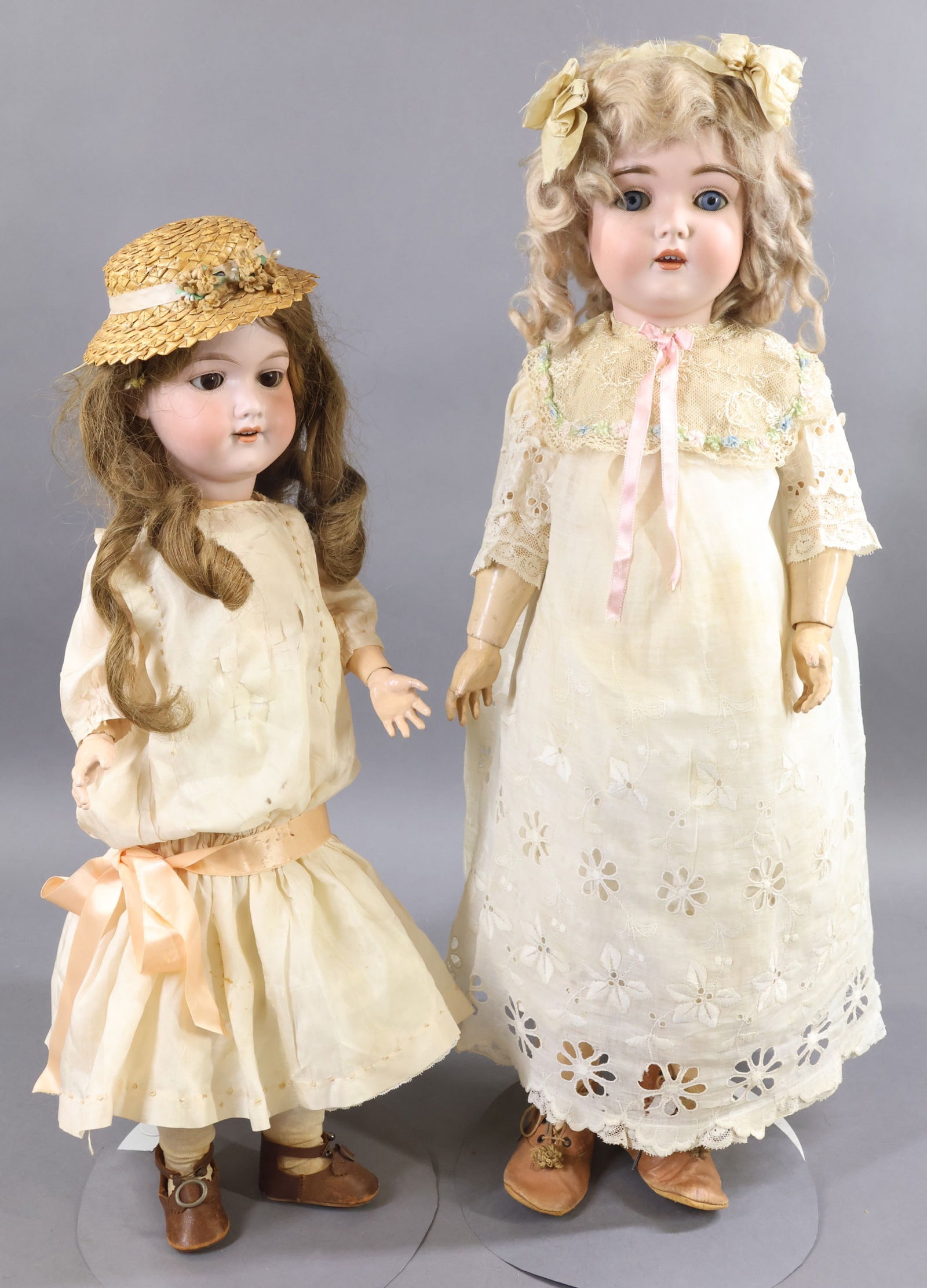 ANTIQUE GERMAN BISQUE DOLLS.: Pair of dolls. Both dolls have open mouths, sleep eyes, original wigs, papier mache ball jointed bodies and are wearing antique clothing. Doll 1) 25" T. MADE IN GERMANY 13. 171 (KESTNER) with blue eye