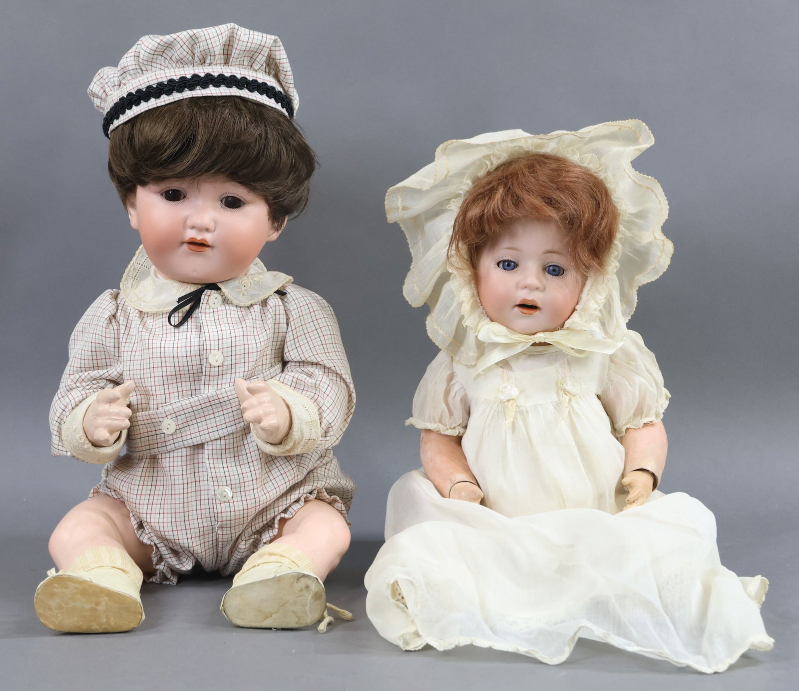 GERMAN BISQUE BABIES.: Pair of character dolls. Both have sleep eyes, open mouths, papier mache bent limb baby bodies. Doll 1) 17" ARMAND MARSEILLE A.975.M GERMANY 8. with brown eyes, synthetic wig. 5 Pc. body. Dressed in a