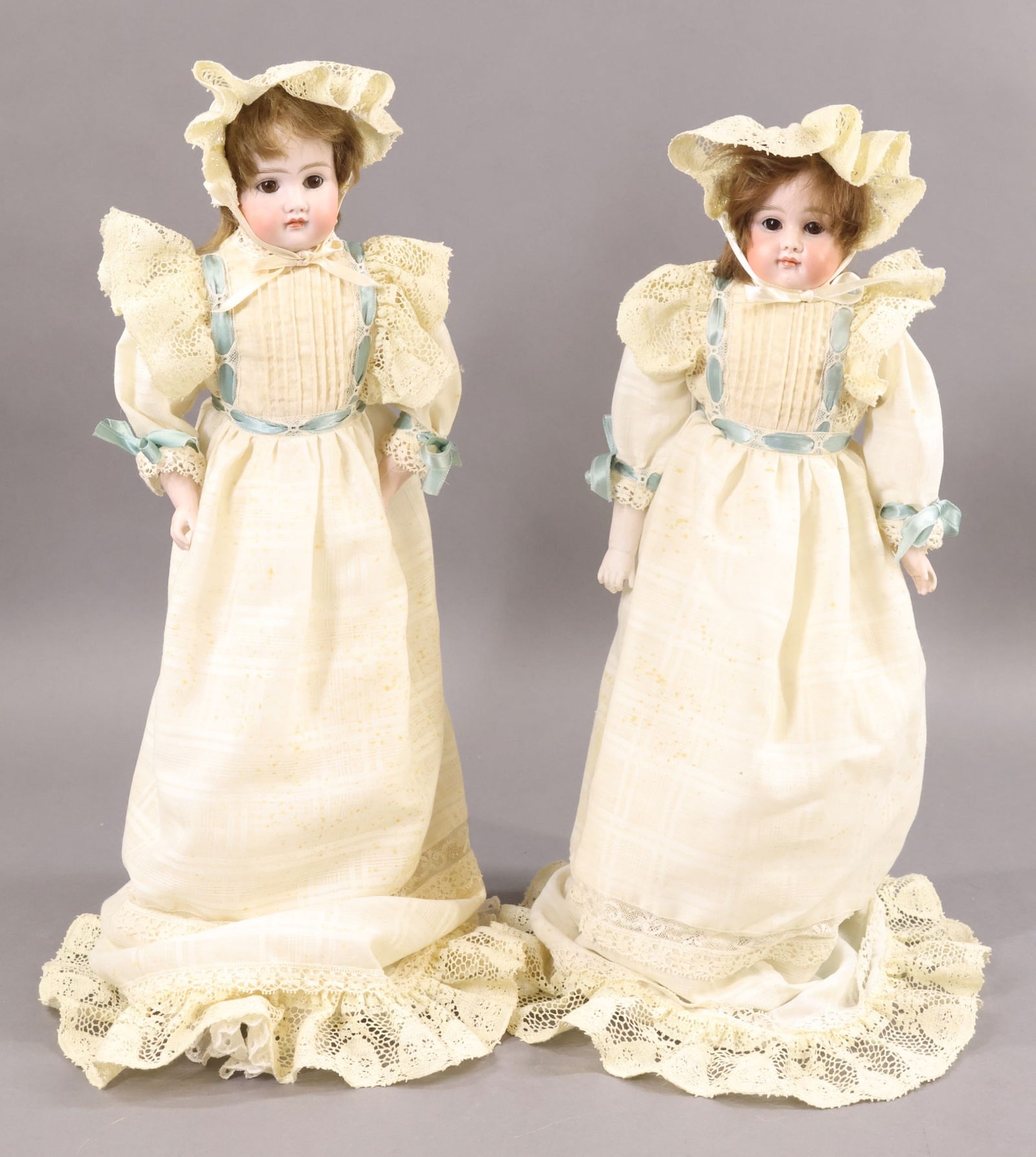 GERMAN BISQUE DOLLS..: Pair of "6" shoulder head dolls with closed mouths. Each one has a leather gusseted body, bisque lower arms, brown mohair wig, brown eyes. Doll 1) 16" has sleep eyes. Doll 2) 17" has stationary eyes .