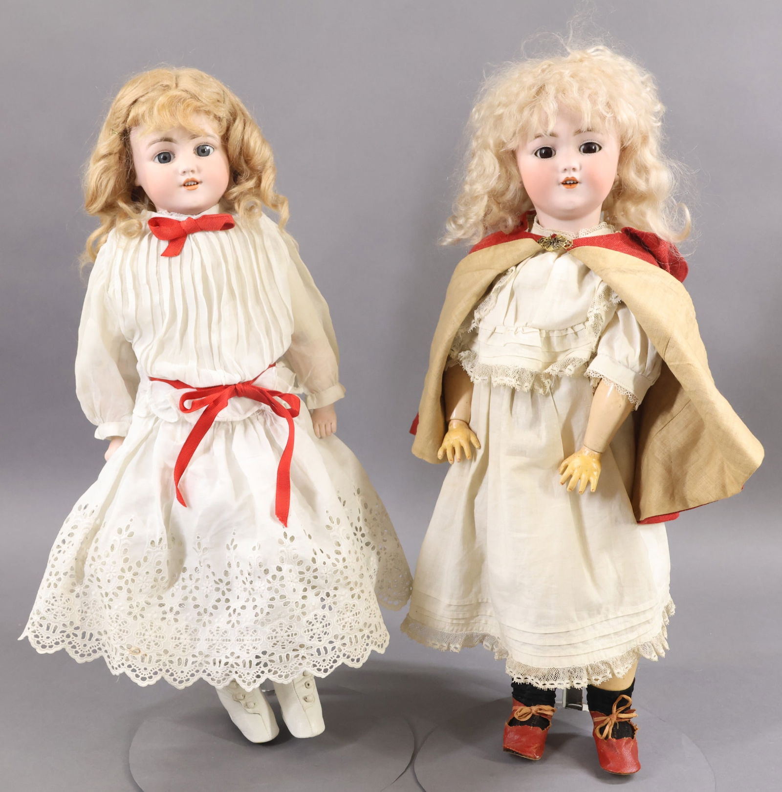 GERMAN BISQUE DOLLS.: Pair of SIMON & HALBIG dolls. Both dolls have sleep eyes, open mouths, pierced ears and mohair wigs. They are both dressed in antique white cotton outfits, underwear. Doll 1) 19" S & H 1249 GERMANY DE
