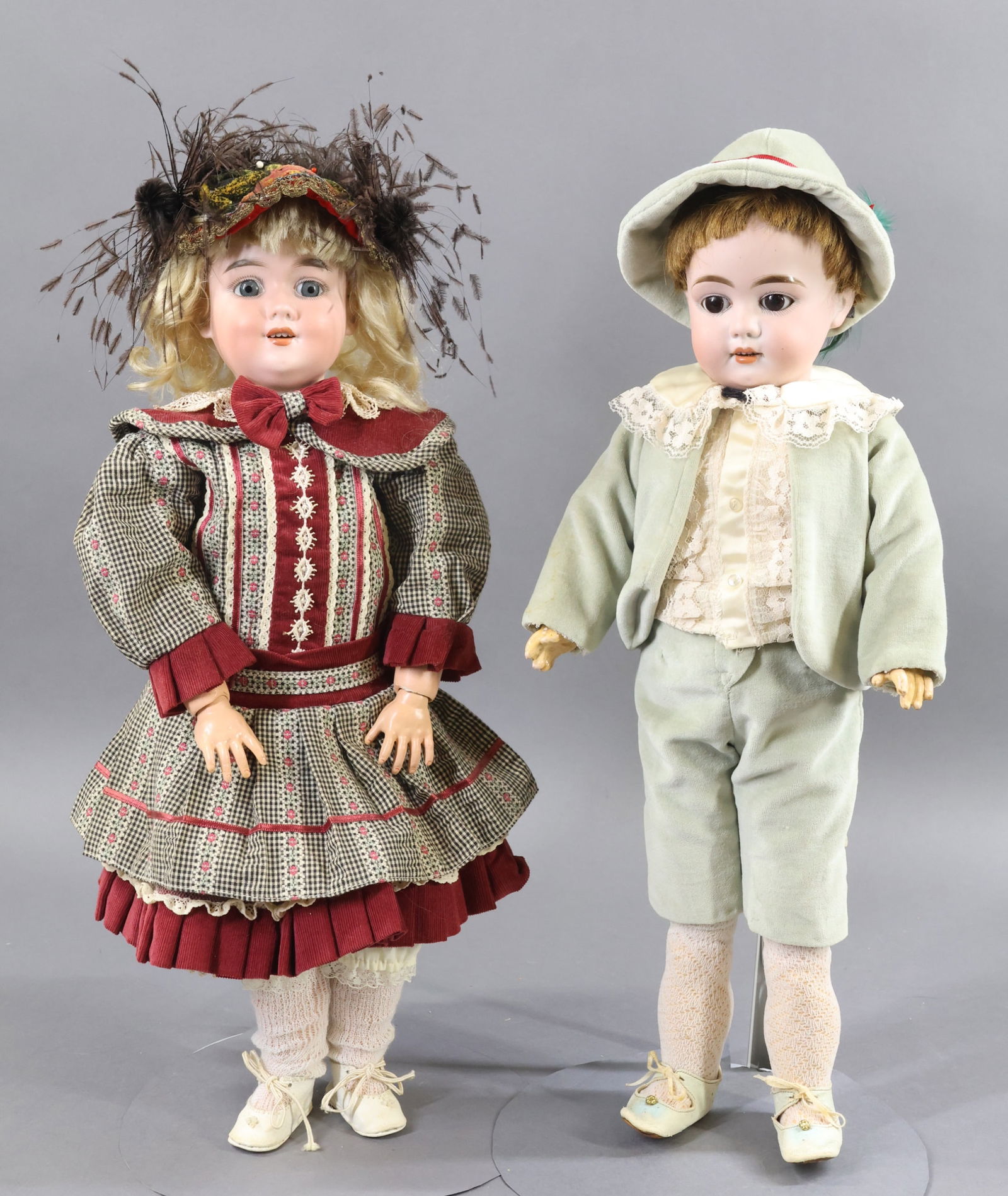 GERMAN BISQUE DOLLS.: Pair of dolls. Both dolls have open mouths, papier mache jointed bodies and have been redressed in vintage outfits with leather shoes. Doll 1) 18 1/2" 1 L.H.K 4. MADE IN GERMANY with brown sleep eyes,