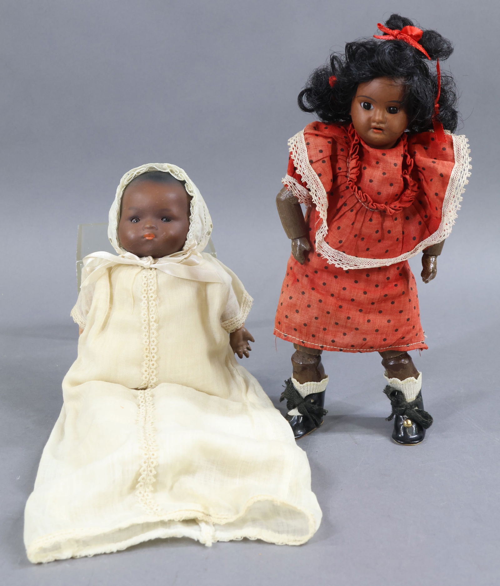 BLACK DOLLS.: Pair of German bisque dolls. 10" 1894 AM 8/0 DEP GERMANY with stationary black eyes, open mouth, black synthetic wig. Papier mache jointed body. Dressed in factory original dress. Replaced new underwe