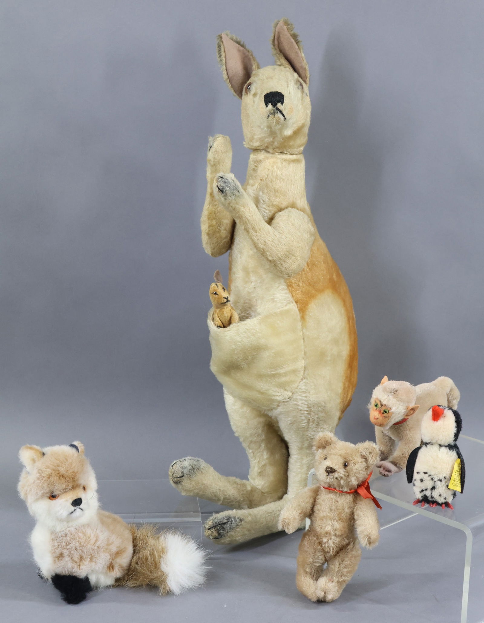 VINTAGE STEIFF.: LOT. Mohair - This item is an original family owned unmarked 19 1/2" (50cm) 1950's Sitting up white/grey/cinnamon "Kanga" Kangaroo. (Holes in ear where button was.) Jointed arms, swivel head. Brown gl