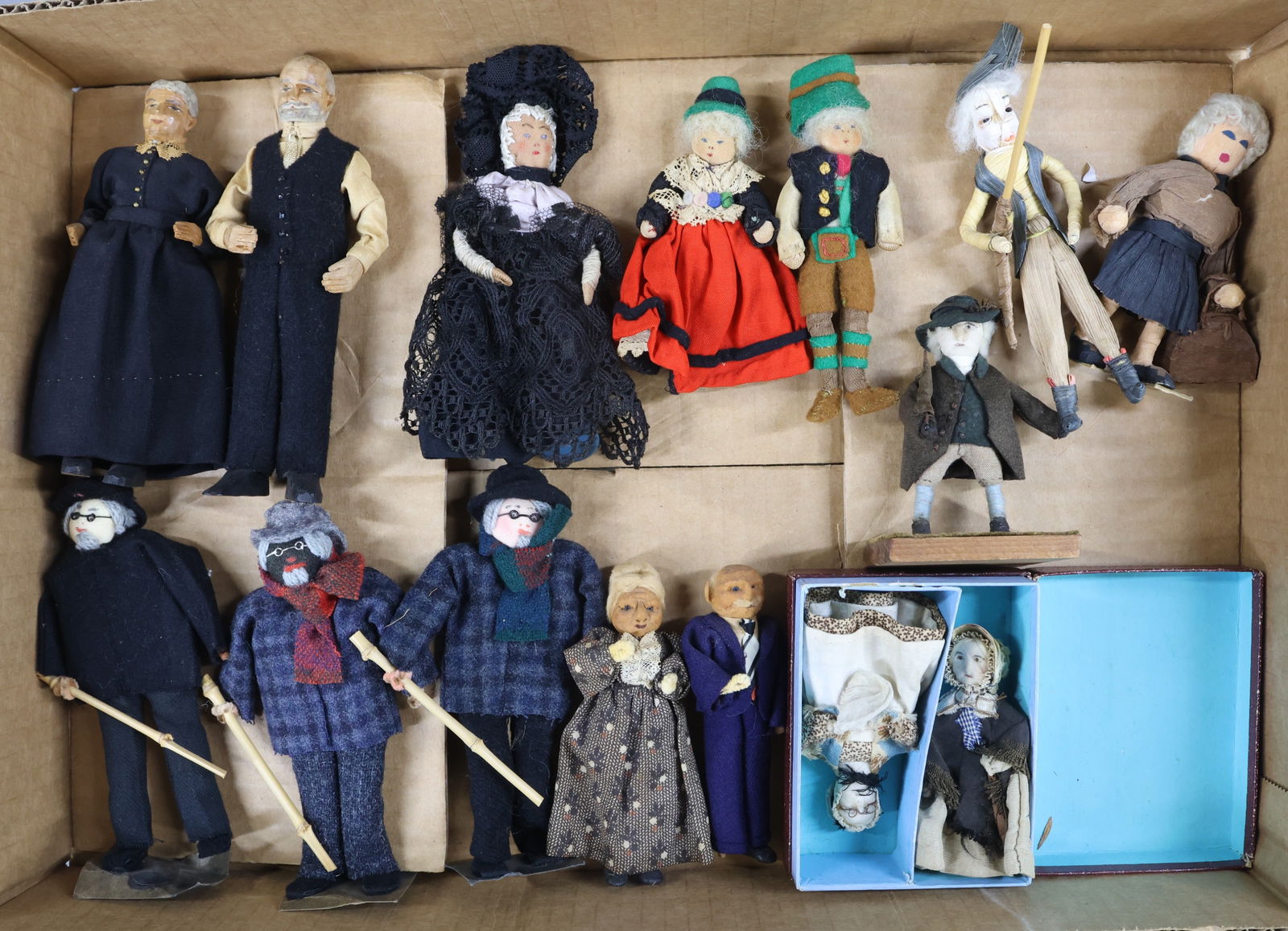 MINIATURES, DOLLS.: DOLLS, other than bisque. 3 1/4" - 6". Carved wood couple. Stockinette couple and lady in black lace dress with hat. (3) Men with cloth heads wearing "glasses". Man and woman signed by artist Evelyn M