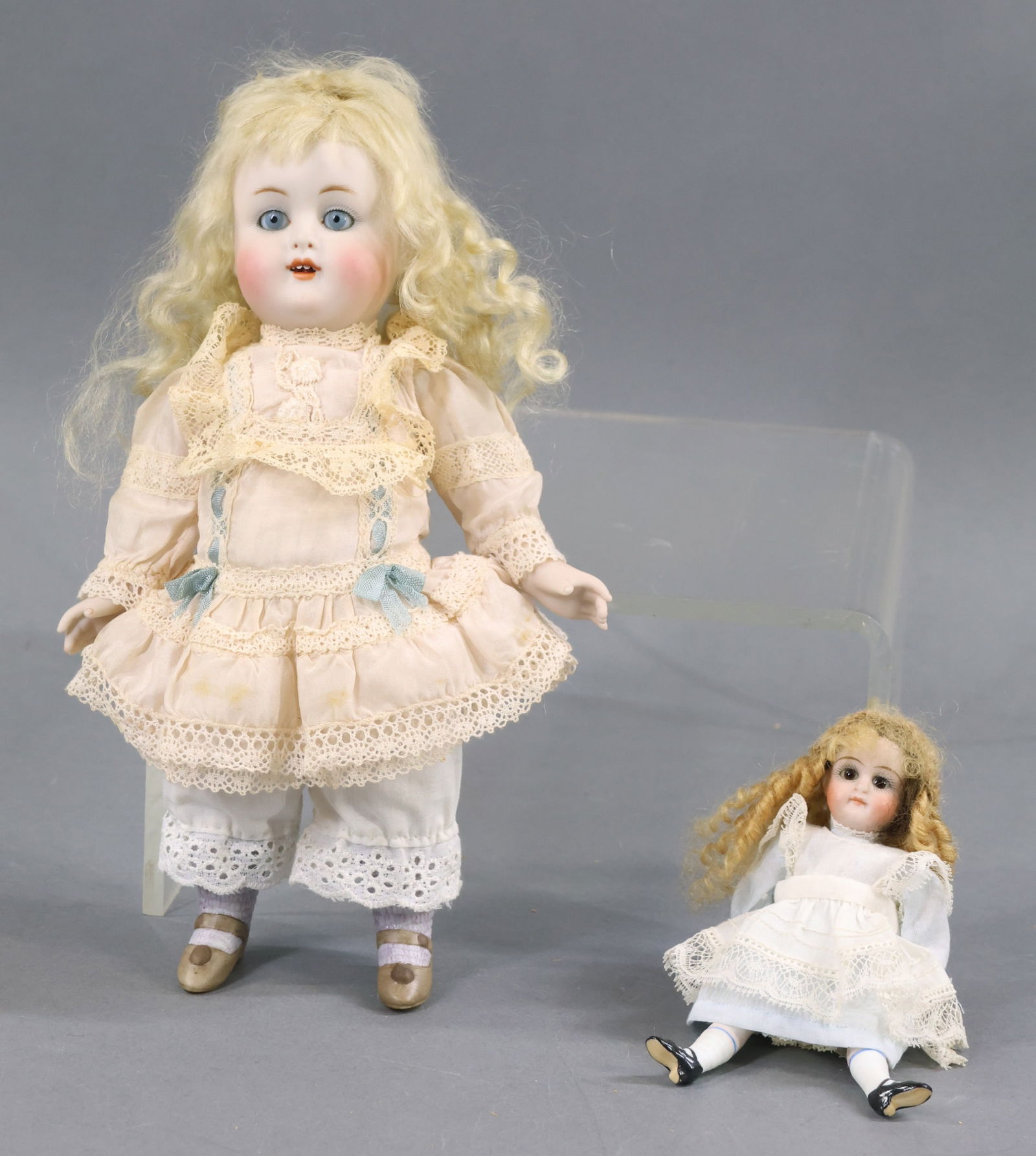 ALL BISQUE DOLLS.: Pair of dolls. Both dolls have stationary eyes, mohair wigs, 5 pc. bodies with painted heeled shoes, socks and dressed in vintage clothing. Antique - 5" 61 5 Doll with brown eyes, closed mouth, long h