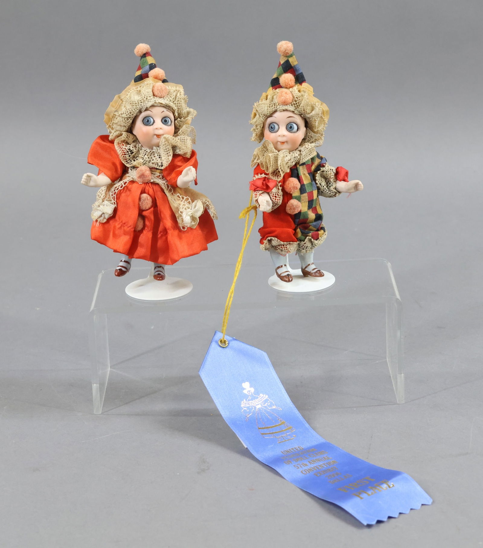 GOOGLY EYE DOLLS.: Pair of 4 1/2" all bisque side glancing blue Googly-eye dolls. Marked 292 10. Closed mouths. One stroke eyebrows. Swivel necks, 5 pc. bodies with painted two strap brown shoes, blue socks. Dressed in