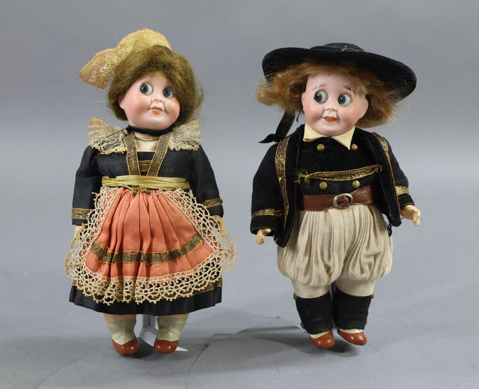 BISQUE GOOGLY EYE DOLLS.: Pair of all factory original 7 1/2" French Googly-eye dolls. Marked 23 S.F.B.J. 245 PARIS. Large blue side glance eyes. Open/closed smiling mouths showing teeth. Boy has a red mohair wig, girl a brown